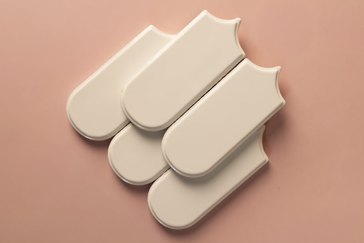 Three beige tiles on a pink background