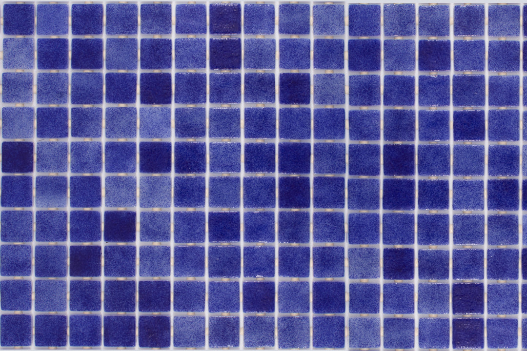 Rich oceanic hues define this glossy Nieve Marino glass mosaic, with its 1-inch squares reflecting light beautifully, seen from above for a clear pattern display.