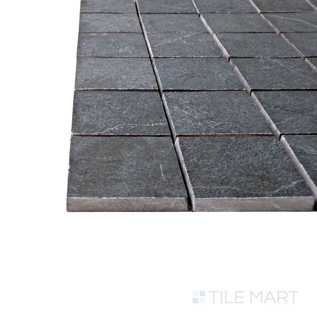 A corner shot of the Ash Black 2" square matte porcelain mosaic tile highlights its deep black tone and uniform grid pattern, creating a sleek and contemporary surface with a refined matte finish.