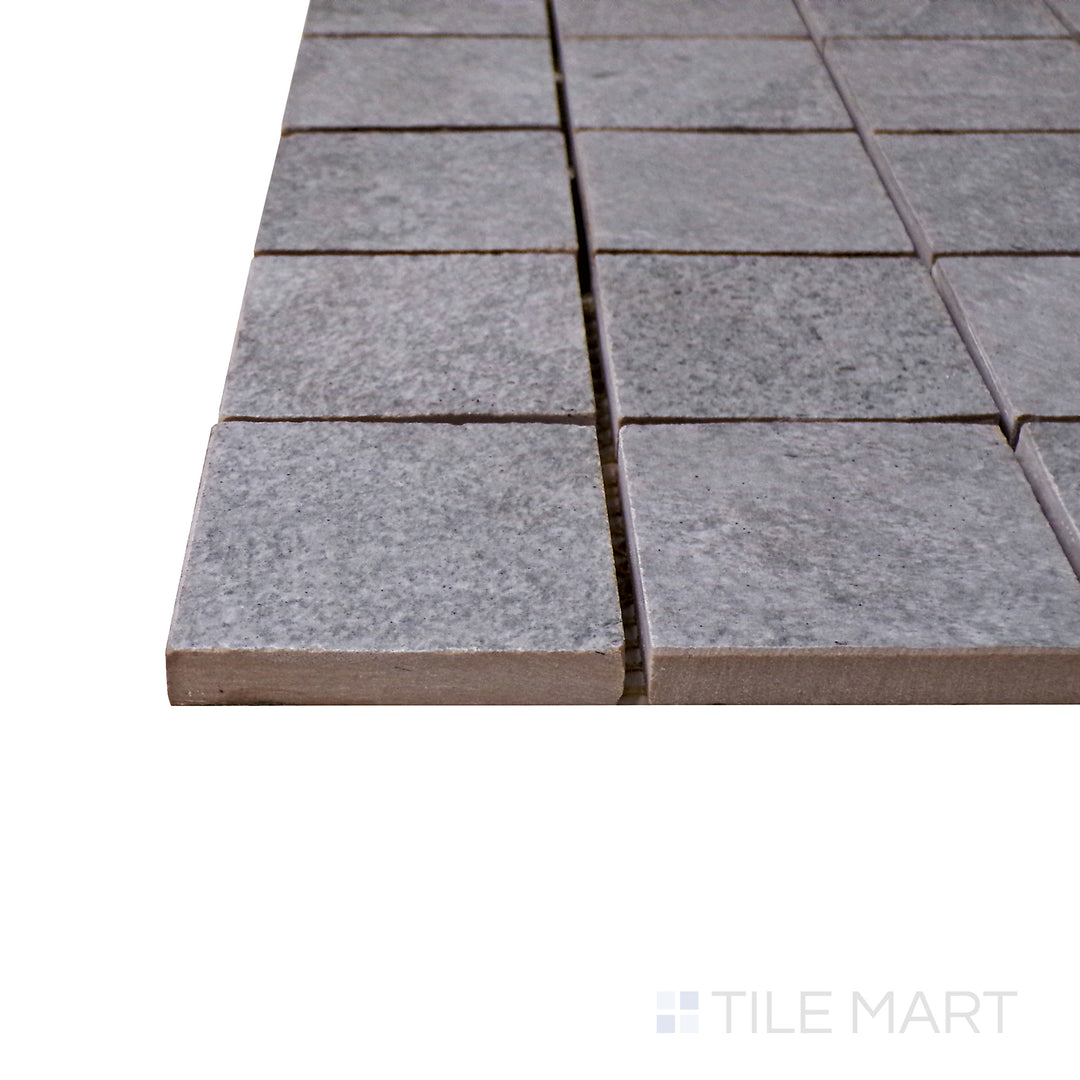 Captured from a corner angle, the Ash Silver 2" square matte porcelain mosaic tile showcases its soft silver-gray shade and structured layout, perfect for adding texture and depth to modern designs.