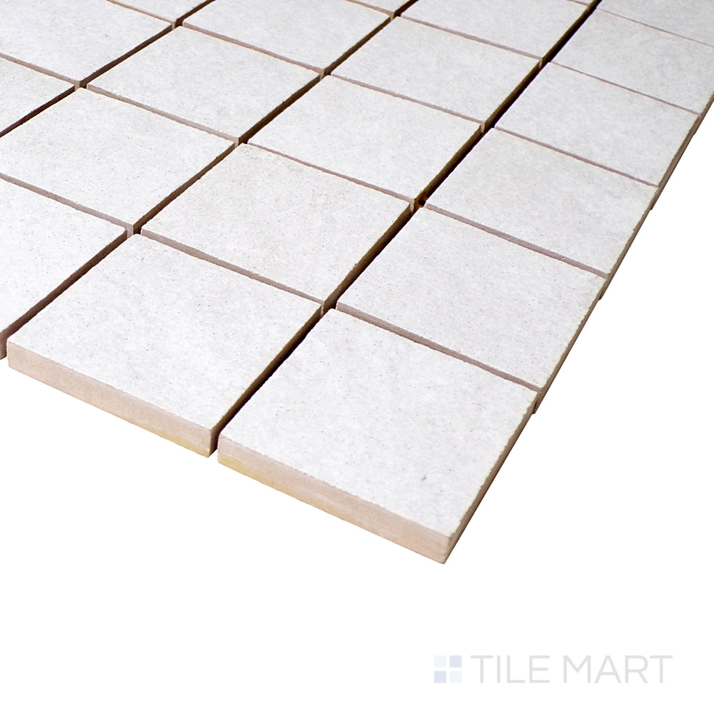 A close-up angle shot captures the clean white mosaic arrangement, showcasing the precision of each square tile with a soft matte touch.