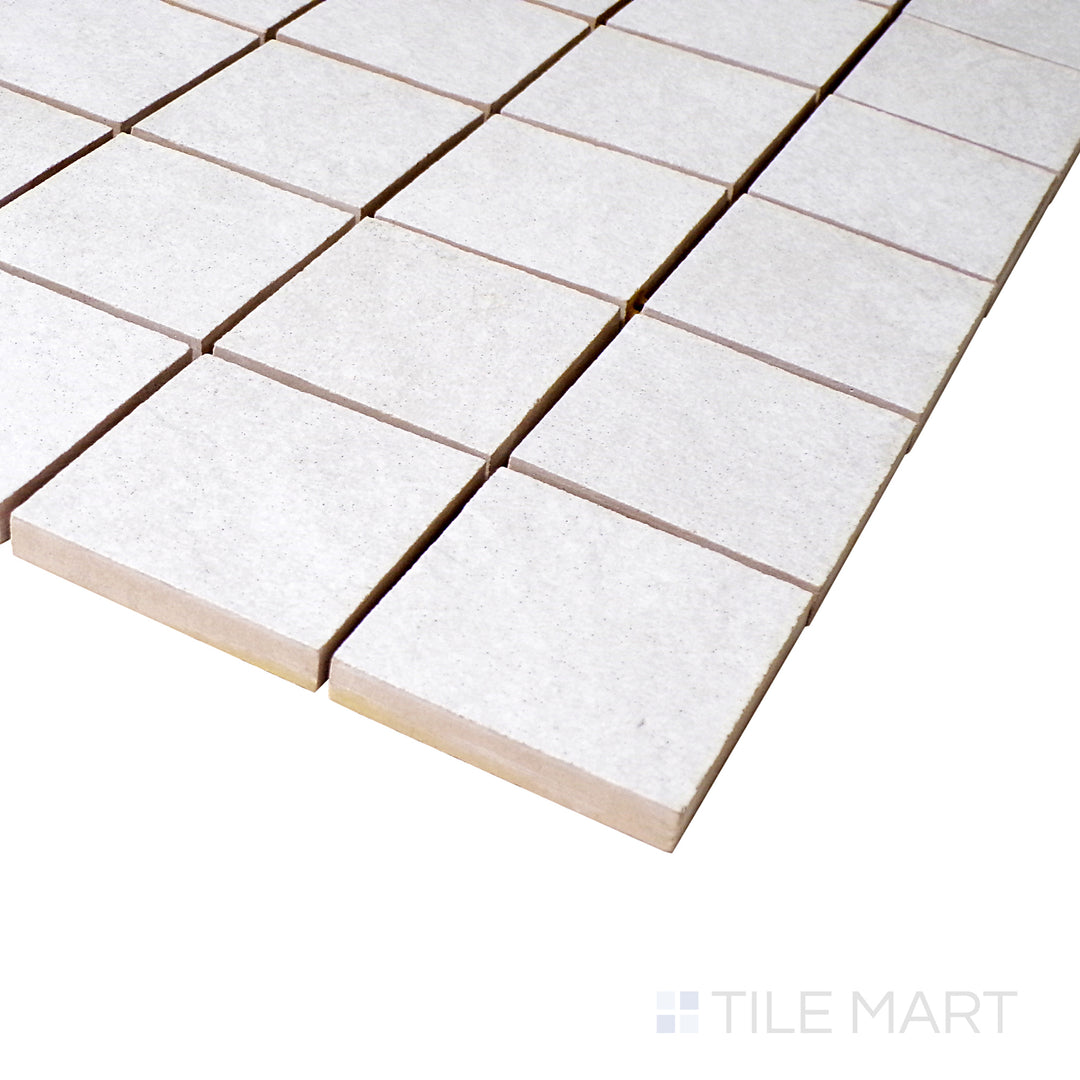 A close-up angle shot captures the clean white mosaic arrangement, showcasing the precision of each square tile with a soft matte touch.