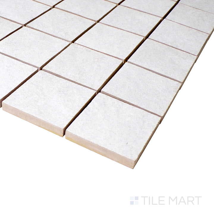 A close-up angle shot captures the clean white mosaic arrangement, showcasing the precision of each square tile with a soft matte touch.