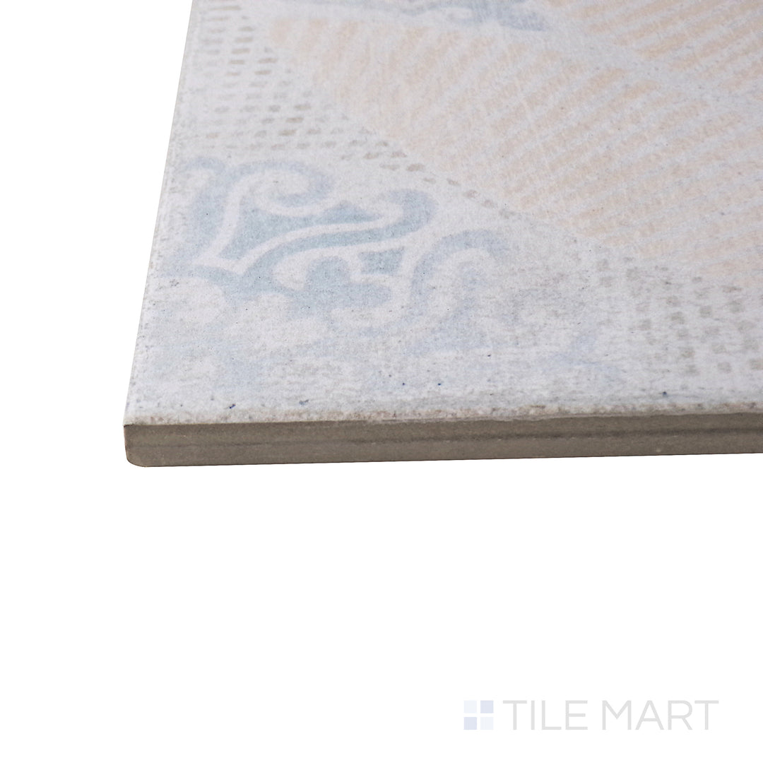 Captured from a corner angle, the Barcelona Décor Guell 6x6 matte porcelain tile showcases its ornate design and muted tones, offering a classic yet artistic look.