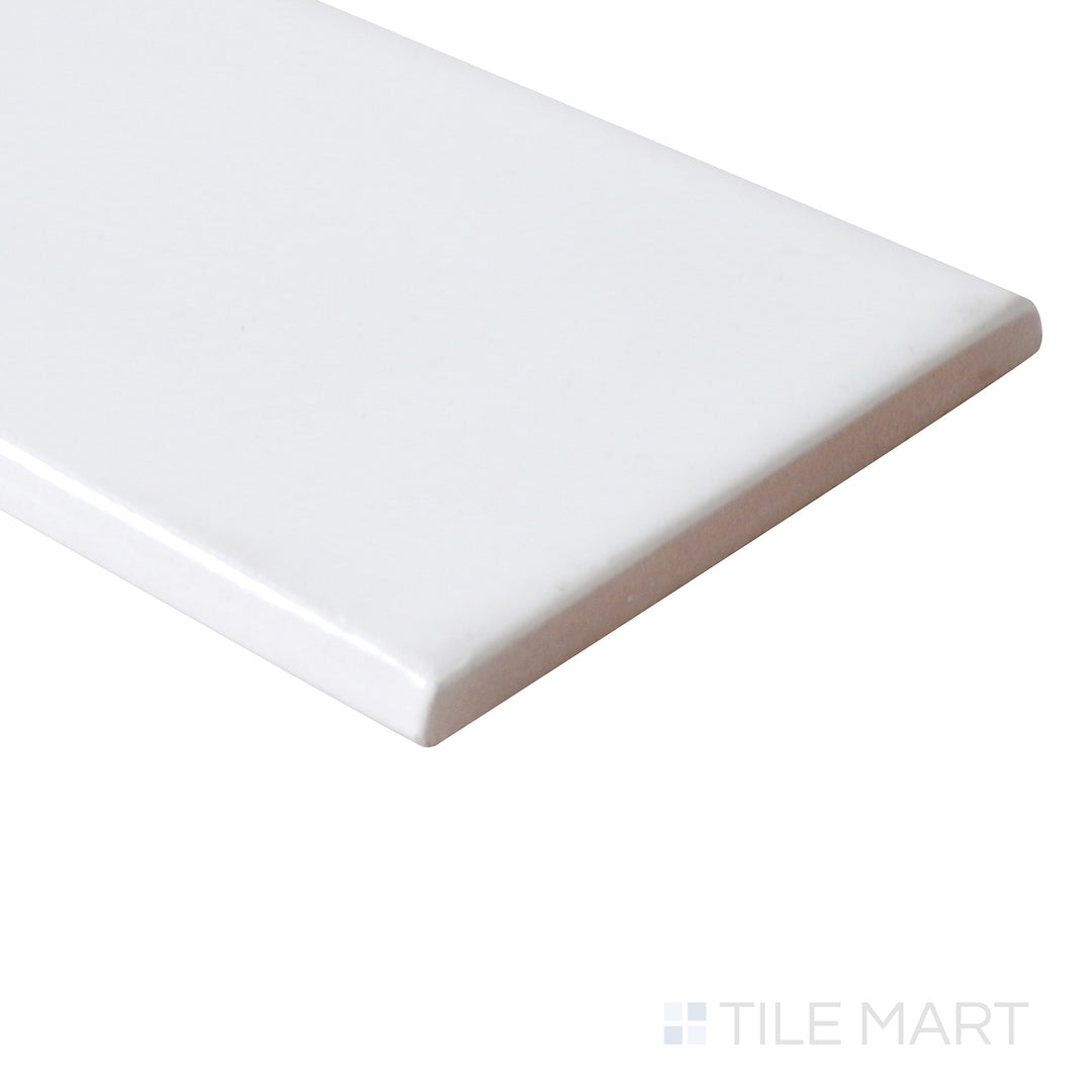 The glossy bullnose edge is accentuated from an angle, offering a seamless and polished finish to this white ceramic tile.