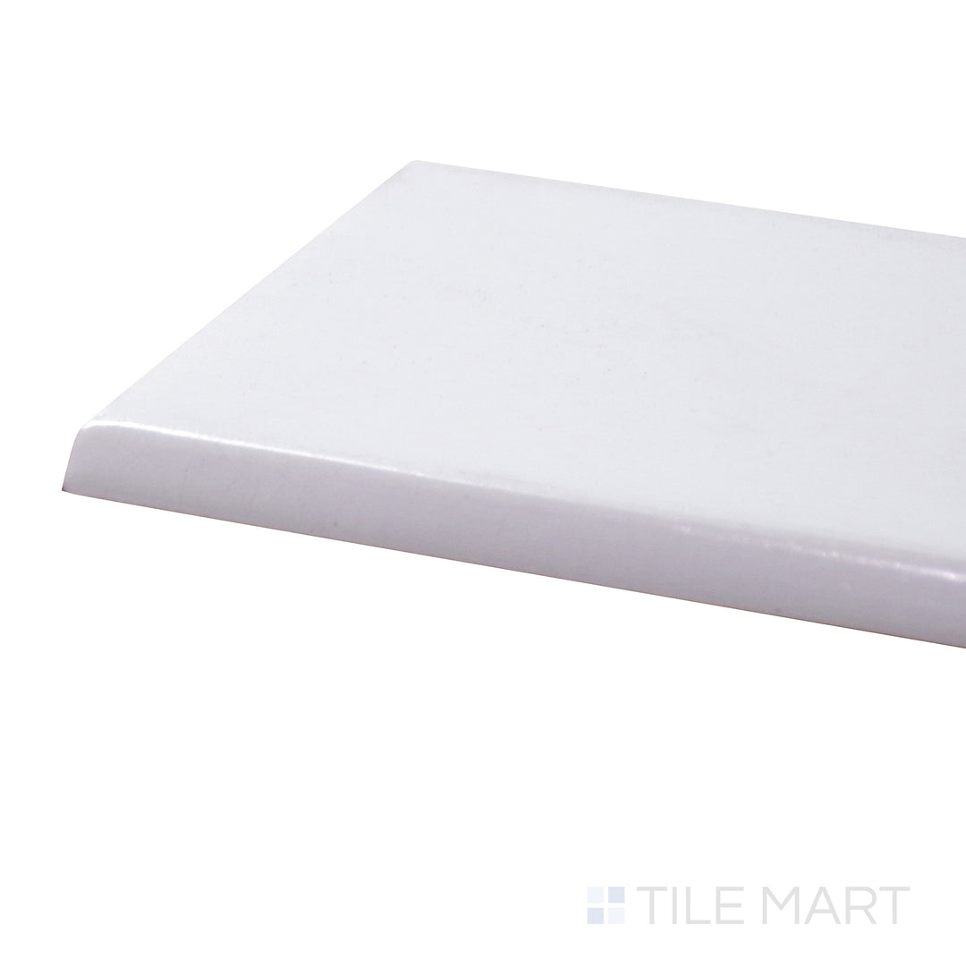 A corner shot of the Basics White 3x6 glossy ceramic bullnose tile presents its smooth, rounded edge and glossy surface, perfect for seamless transitions and finishing touches.