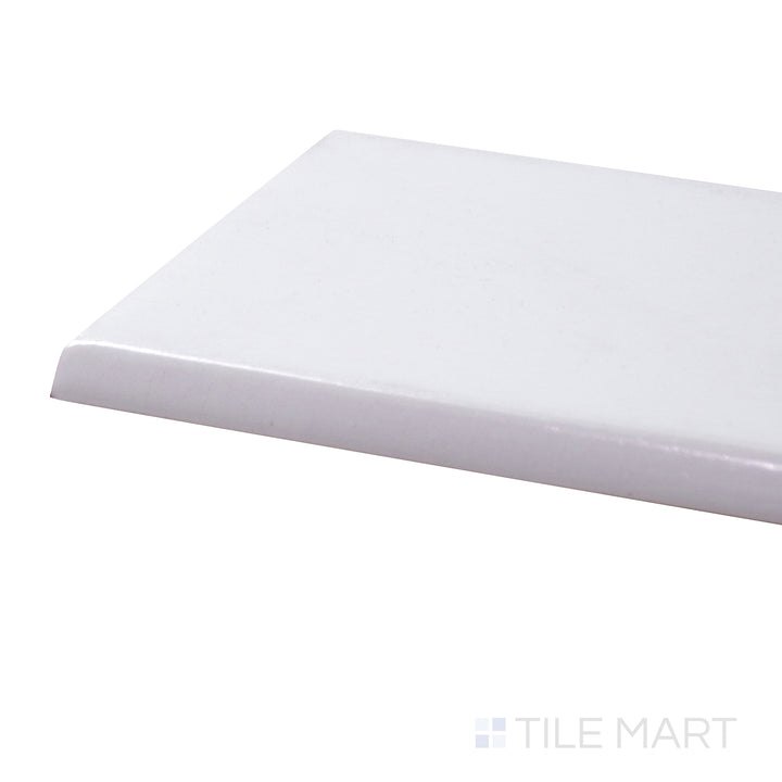A corner shot of the Basics White 3x6 glossy ceramic bullnose tile presents its smooth, rounded edge and glossy surface, perfect for seamless transitions and finishing touches.