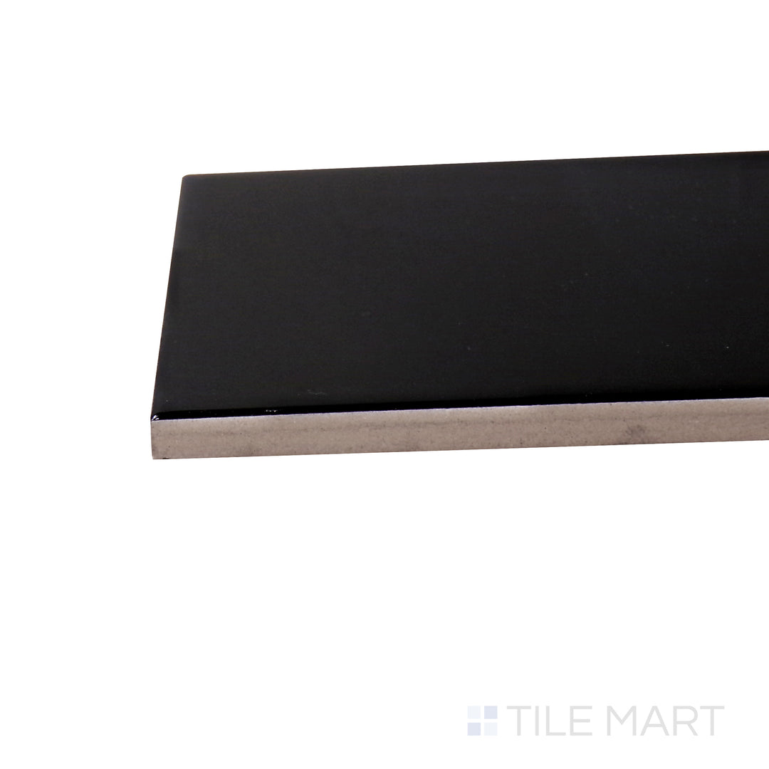 Captured from a corner angle, the Basics Black 3x12 glossy ceramic tile showcases its deep black tone and reflective finish, adding a bold, modern touch to walls and backsplashes.