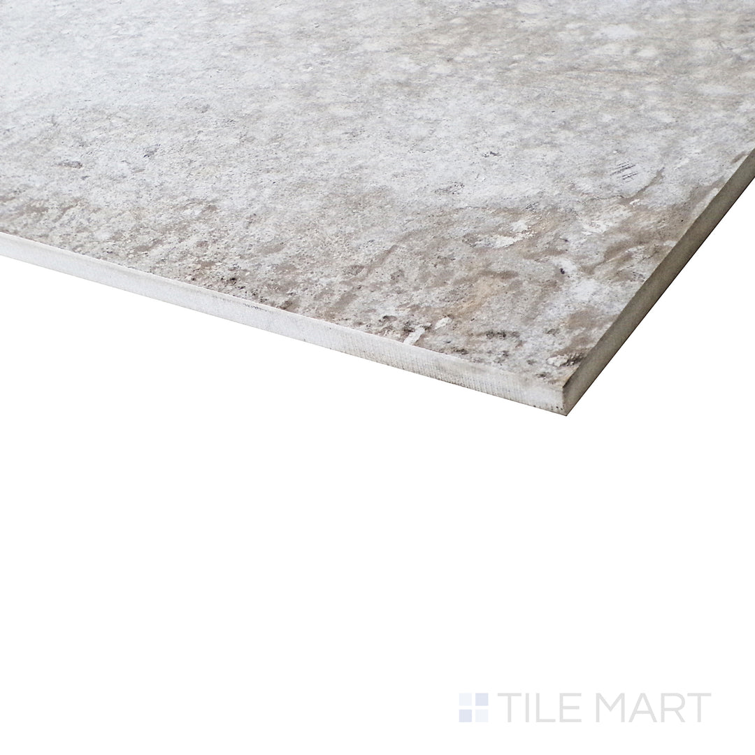 A dynamic angle captures the soft honed texture of the Brooklyn Cemento Argent tile, showcasing its modern cement-inspired surface.