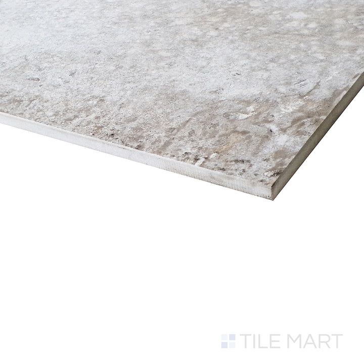 A dynamic angle captures the soft honed texture of the Brooklyn Cemento Argent tile, showcasing its modern cement-inspired surface.