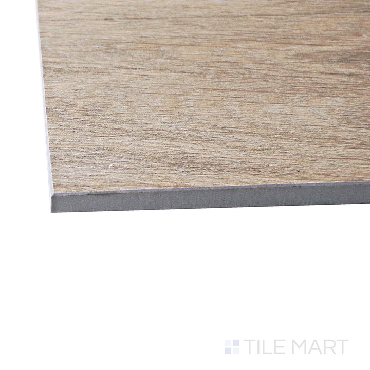 Captured from a corner angle, the Century Wood Look Honey 9.84x59.1 matte porcelain tile showcases its rich honey-toned wood grain detailing, adding warmth and character to any space.