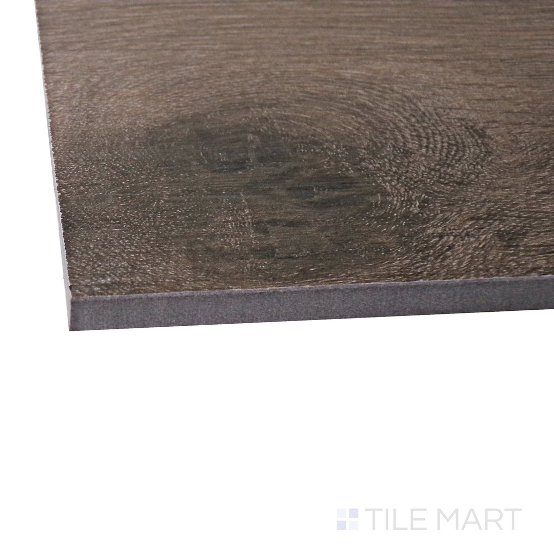 A corner perspective of the Century Wood Look Brown 9.84x59.1 matte porcelain tile emphasizes its deep brown wood-inspired design and matte surface, offering the beauty of hardwood with porcelain durability.
