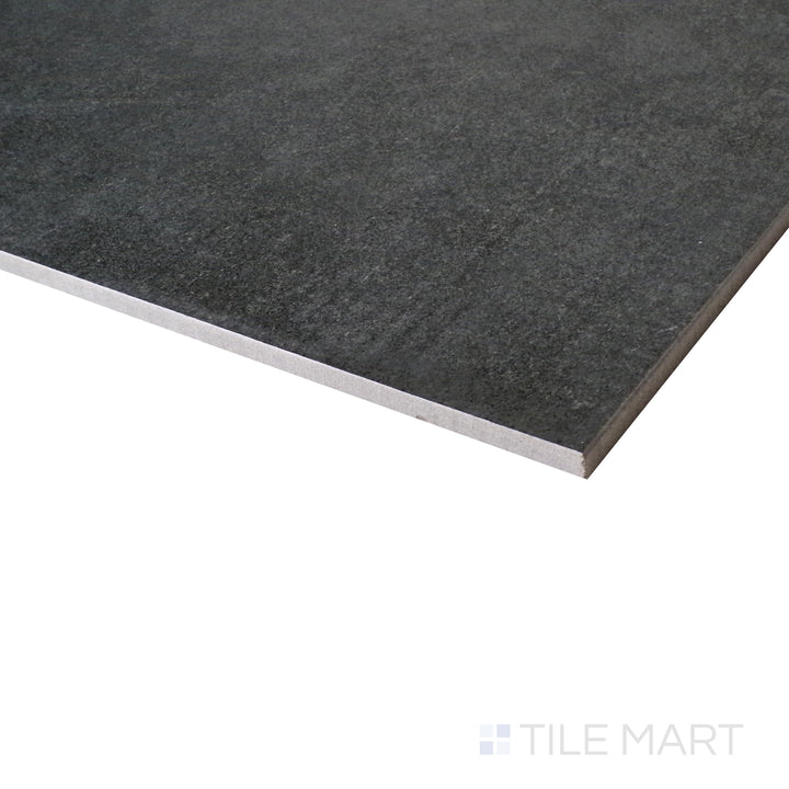 A close-up angle captures the industrial charm of the anthracite matte porcelain tile, emphasizing its raw elegance.