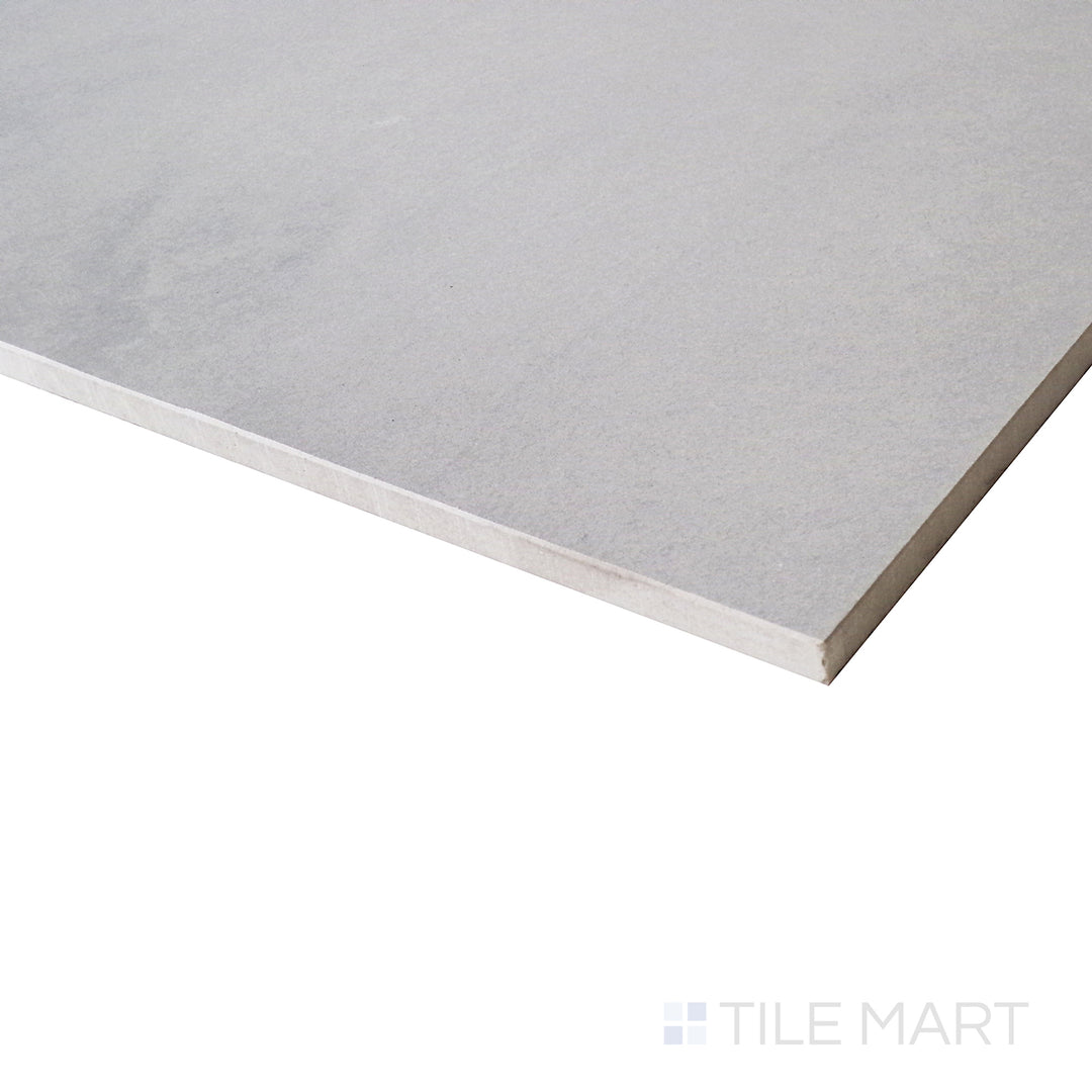 An angled close-up showcases the cool gray tones of this matte tile, with subtle variations that enhance its stone-inspired aesthetic.