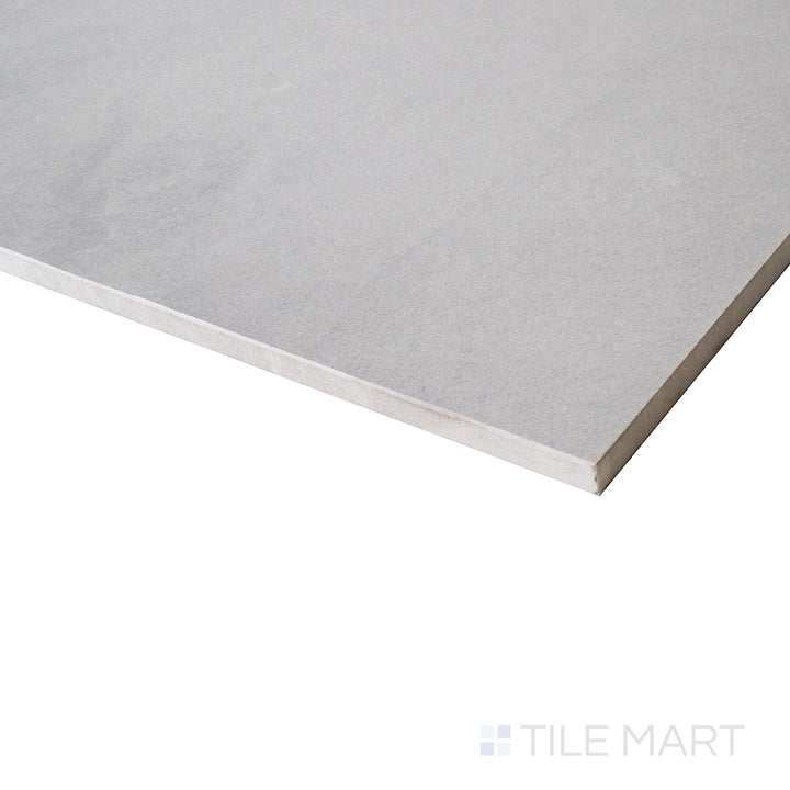 An angled close-up showcases the cool gray tones of this matte tile, with subtle variations that enhance its stone-inspired aesthetic.