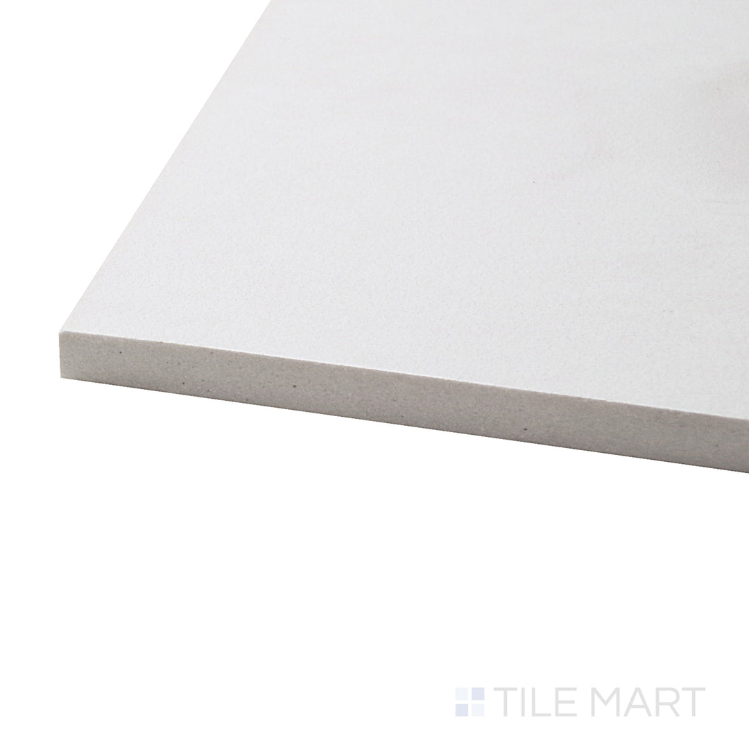 A corner shot of the Creos Bride 12x24 matte porcelain tile highlights its crisp white color and smooth matte texture, ideal for brightening up walls and floors with a minimalist touch.