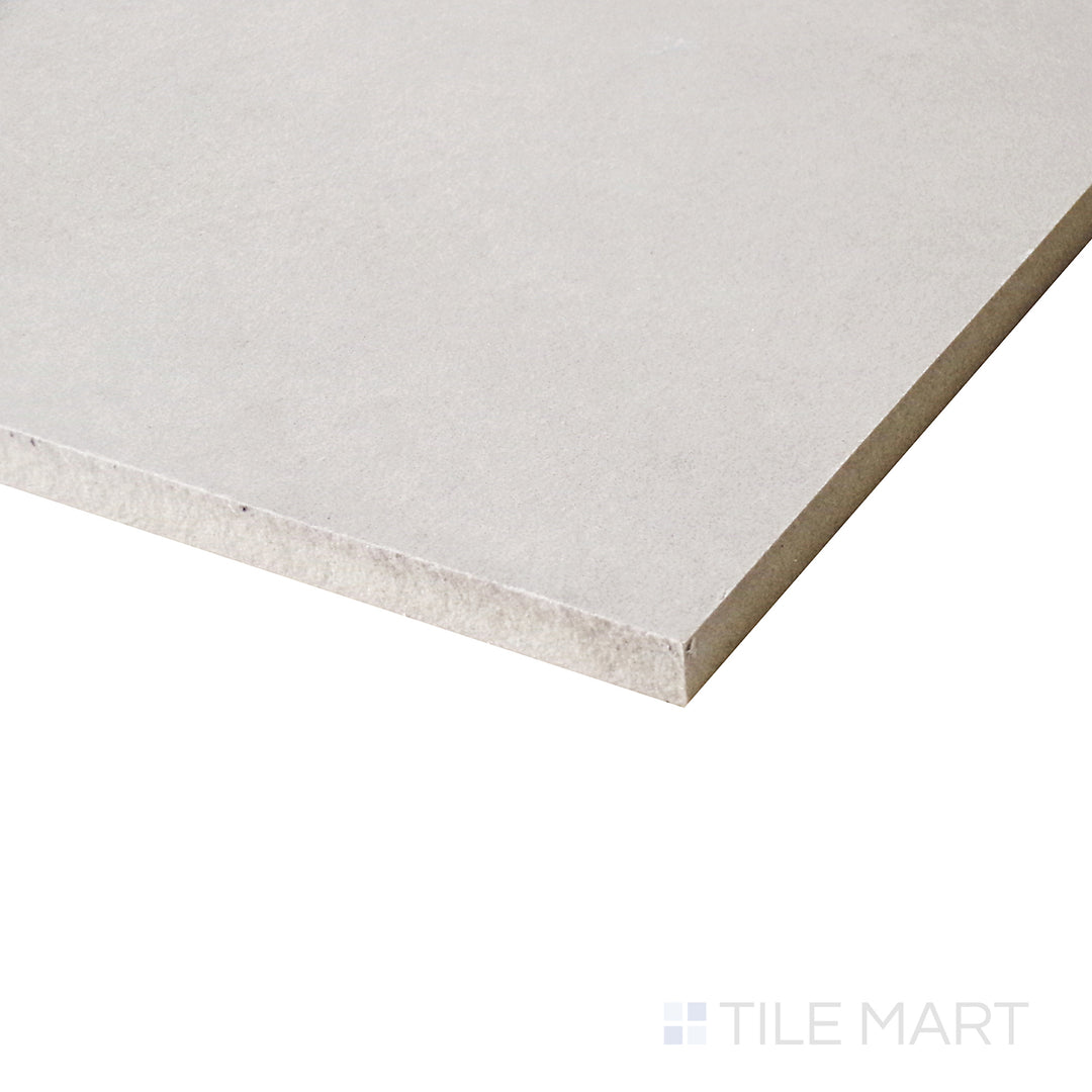 A soft angle captures the inviting warmth of this porcelain tile, highlighting its smooth matte surface and subtle tonal variations.