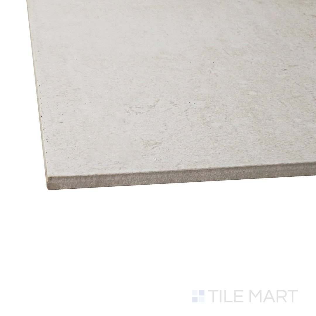 Captured from a corner angle, the Ecocrete Melted Ice 18x36 honed porcelain tile showcases its cool, icy gray shade and honed texture, offering a sleek and modern foundation for any space.