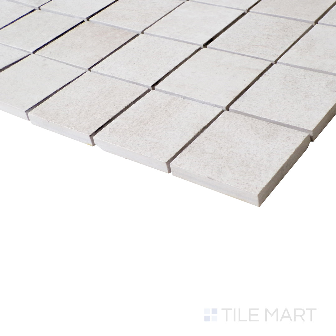 An angled close-up showcases the crisp, modern grid pattern of this matte mosaic, with a cool, ice-toned finish.