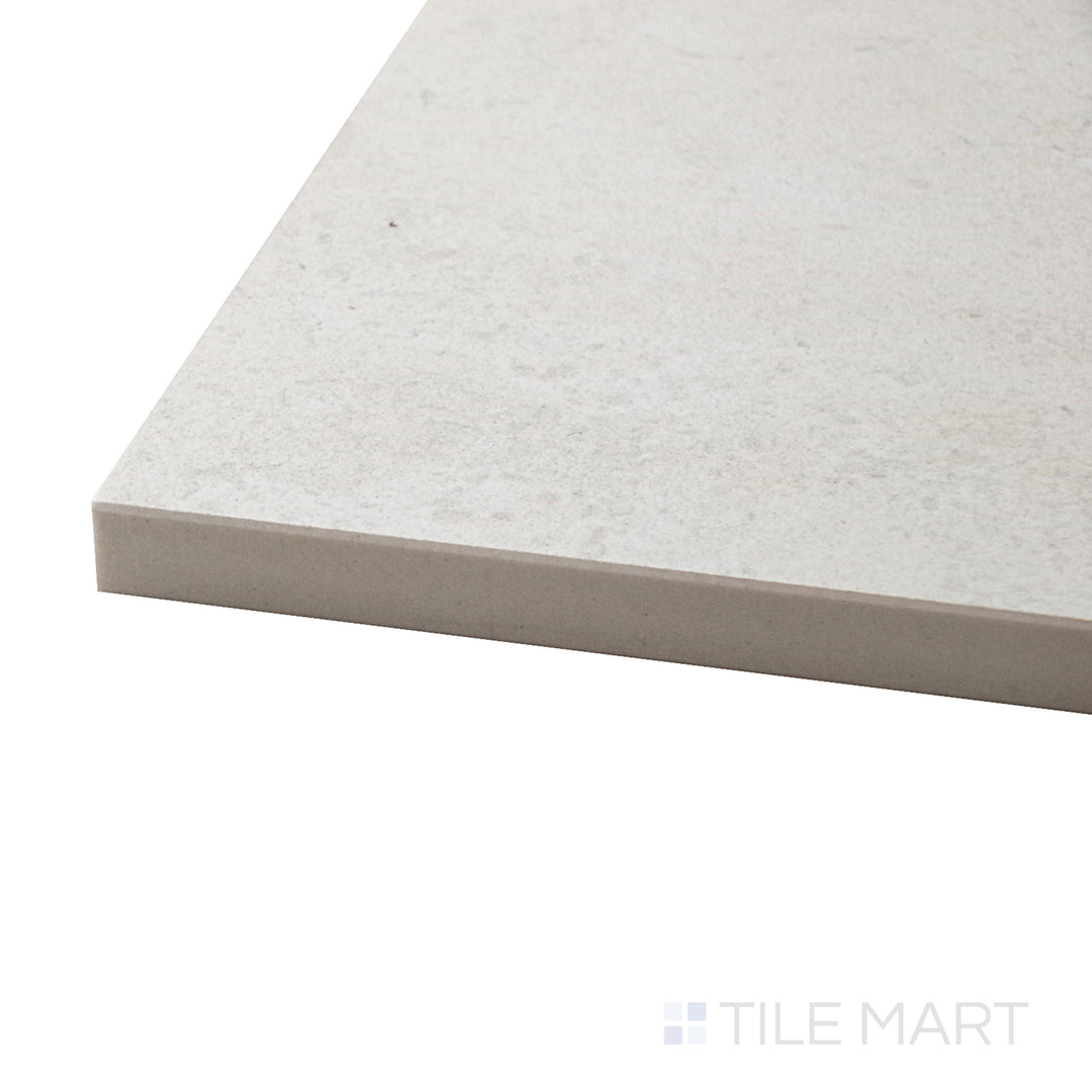 Captured from a corner angle, the Epika Ivory 48x48 matte porcelain tile showcases its soft ivory hue and refined matte finish, offering a sophisticated and timeless aesthetic.