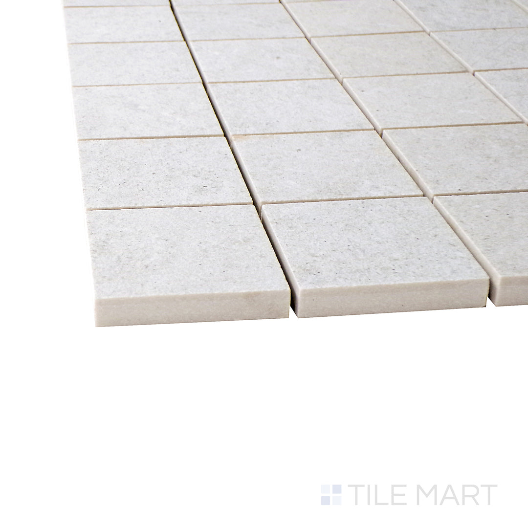 A corner shot of the Epika Pearl 2" square matte porcelain mosaic tile highlights its soft pearl hue and structured grid pattern, adding elegance and texture to walls and floors.