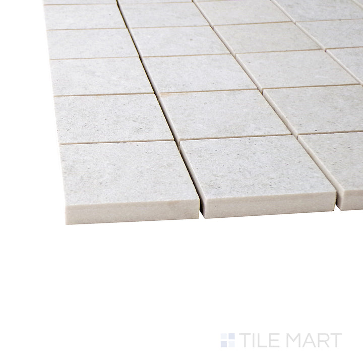 A corner shot of the Epika Pearl 2" square matte porcelain mosaic tile highlights its soft pearl hue and structured grid pattern, adding elegance and texture to walls and floors.