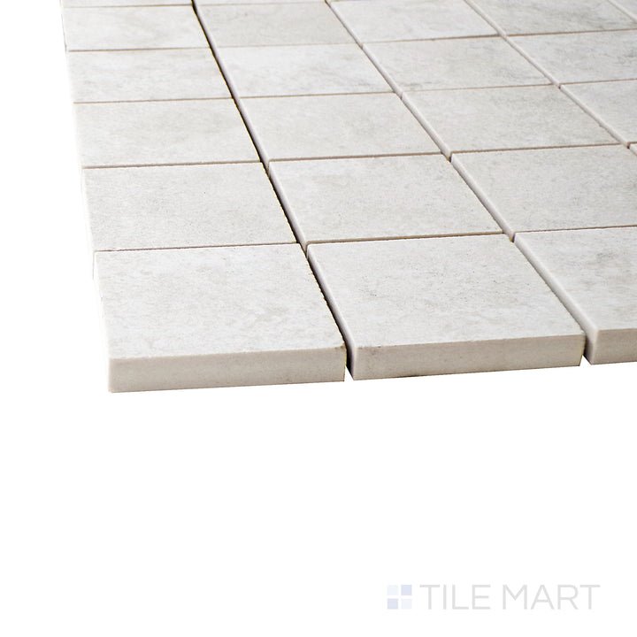 A corner perspective of the Epika Ivory 2" square matte porcelain mosaic tile emphasizes its creamy ivory shade and smooth matte texture, creating a timeless and sophisticated appeal.