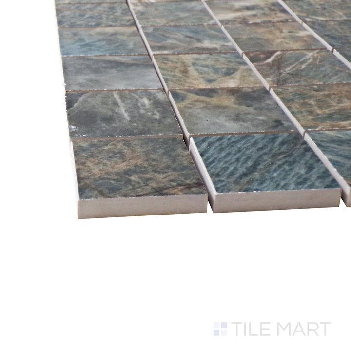 A corner perspective of the Exotic Stone Cosmopolitan Amazzonite 2" square polished porcelain mosaic tile emphasizes its vibrant greenish-blue hues and glossy finish, creating a refined accent.