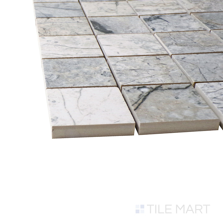 Captured from a corner angle, the Exotic Stone Cosmopolitan Mystic Grey 2" square polished porcelain mosaic tile showcases its rich gray tones and polished texture, creating a sleek and contemporary effect.