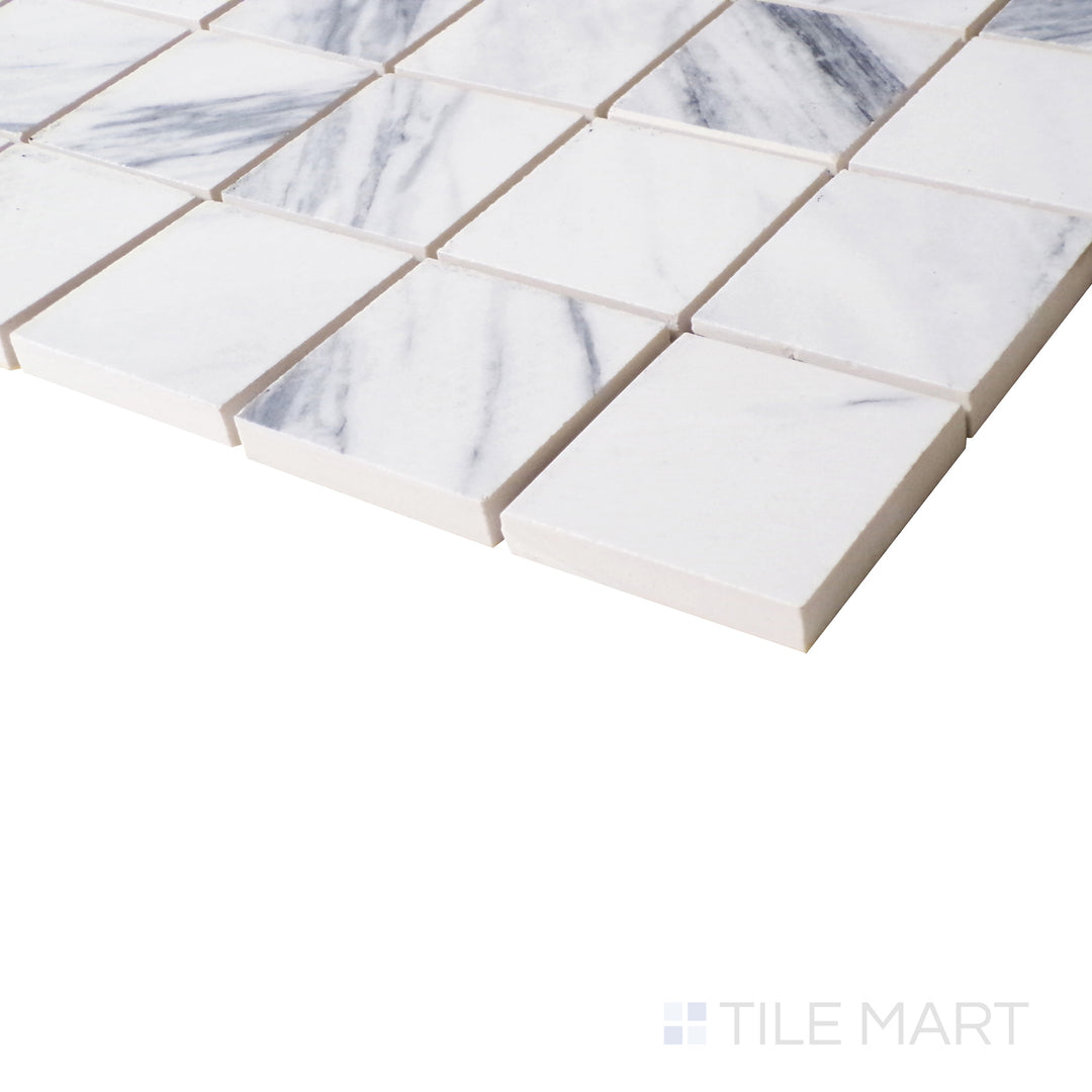 The striking veining of Statuario Fantastico glows under angled lighting, bringing depth to the refined mosaic structure.