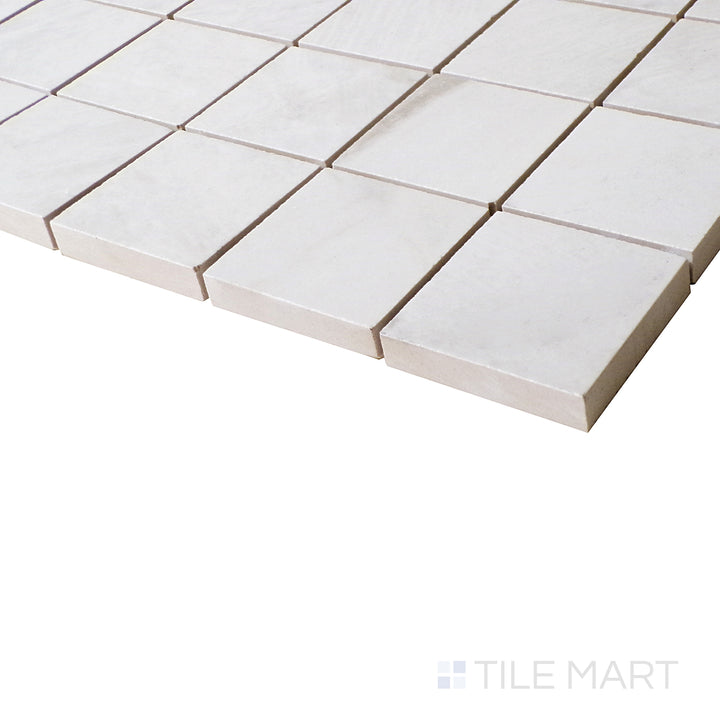 From a close side perspective, Da Vinci White mosaic tiles shimmer with polished perfection, enhancing the neutral and elegant appeal.