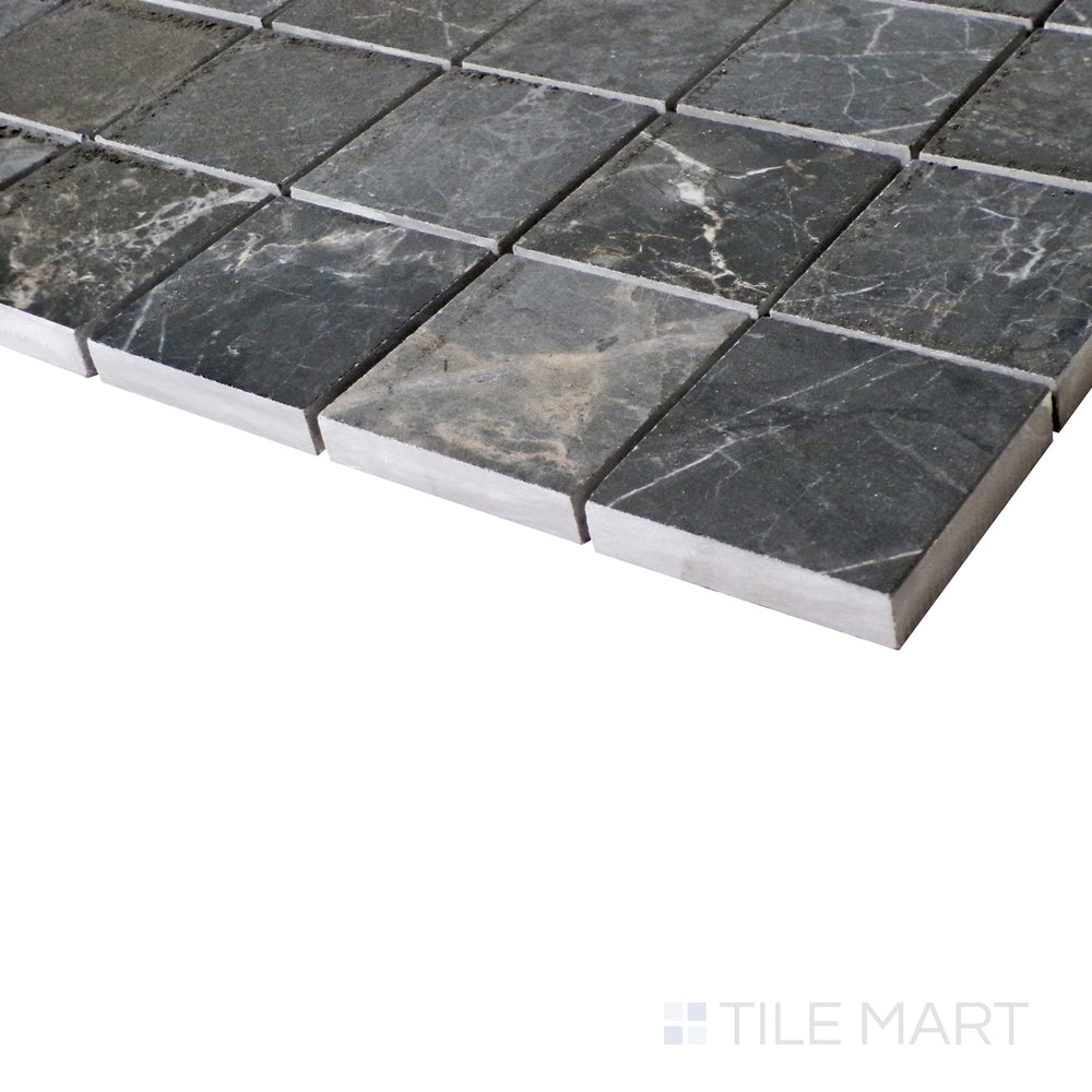 A softly lit side shot highlights the bold gray hues of Soveraya, set in a sleek mosaic layout that enhances its polished effect.