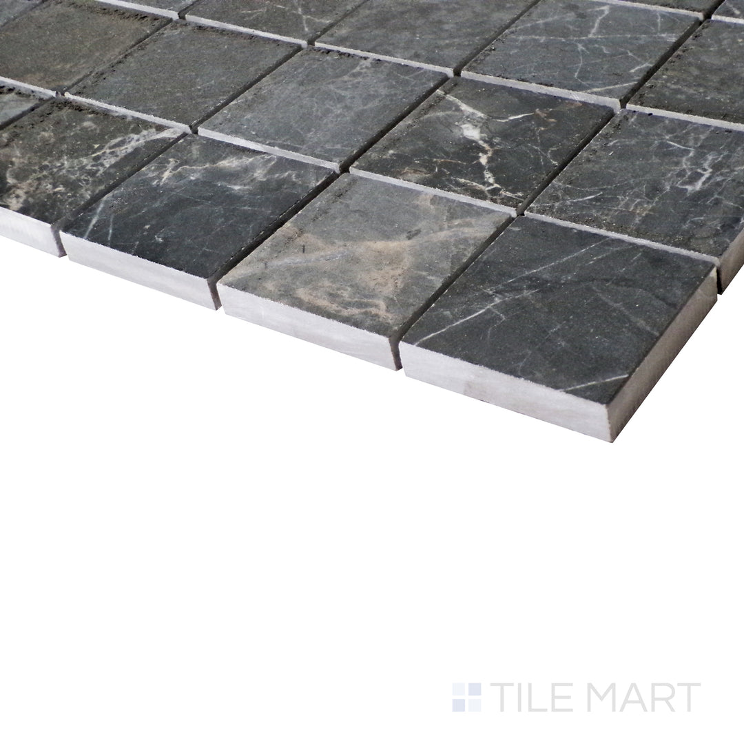 A softly lit side shot highlights the bold gray hues of Soveraya, set in a sleek mosaic layout that enhances its polished effect.