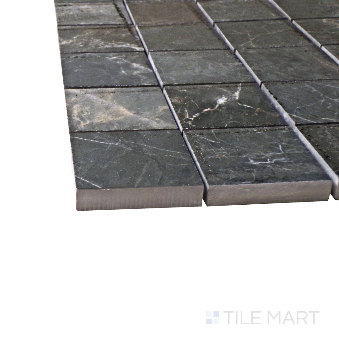 Captured from a corner angle, the Exotic Stone Gray Soveraya 2" square polished porcelain mosaic tile showcases its cool gray hues and smooth glossy texture, enhancing its contemporary appeal.