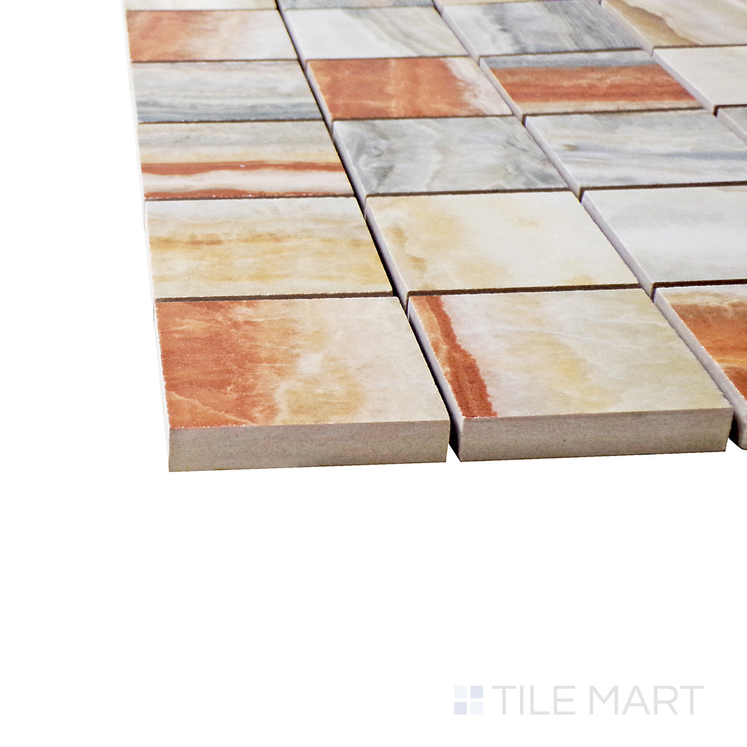 A corner perspective of the Exotic Stone Onice Fantastico 2" square polished porcelain mosaic tile emphasizes its stunning onyx-inspired veining and lustrous finish, adding a touch of opulence.