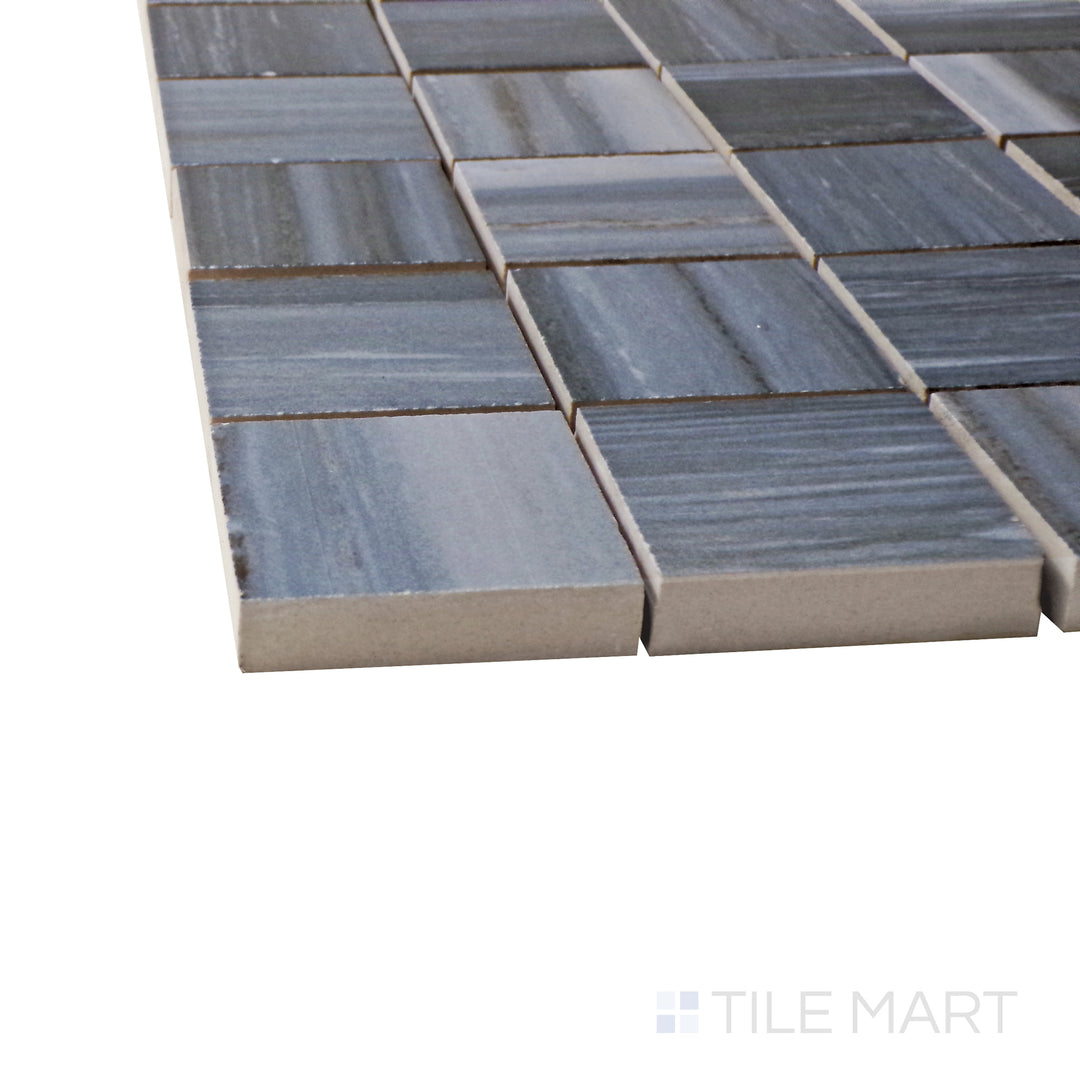 A corner shot of the Exotic Stone Nawan Kendo Blue 2" square polished porcelain mosaic tile highlights its deep blue shades and reflective finish, perfect for bold and artistic applications.