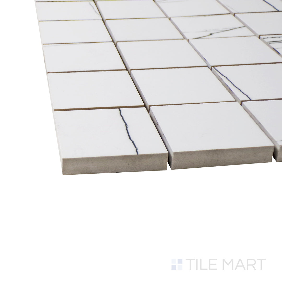 Captured from a corner angle, the Exotic Stone Sahara White 2" square polished porcelain mosaic tile showcases its warm white tones and polished surface, creating a soft and sophisticated accent.