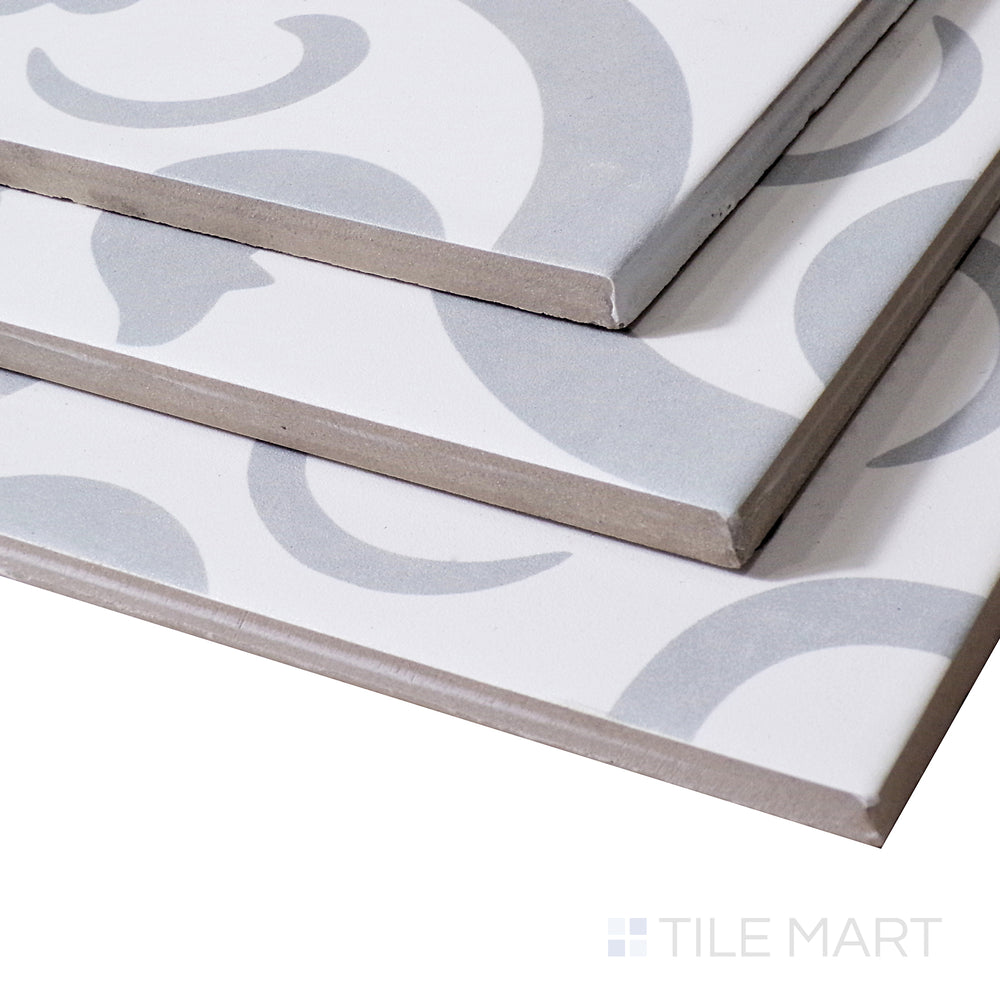 Soft light reflects off the delicate pattern of Perla Chic, highlighting its refined matte texture from an angled perspective.