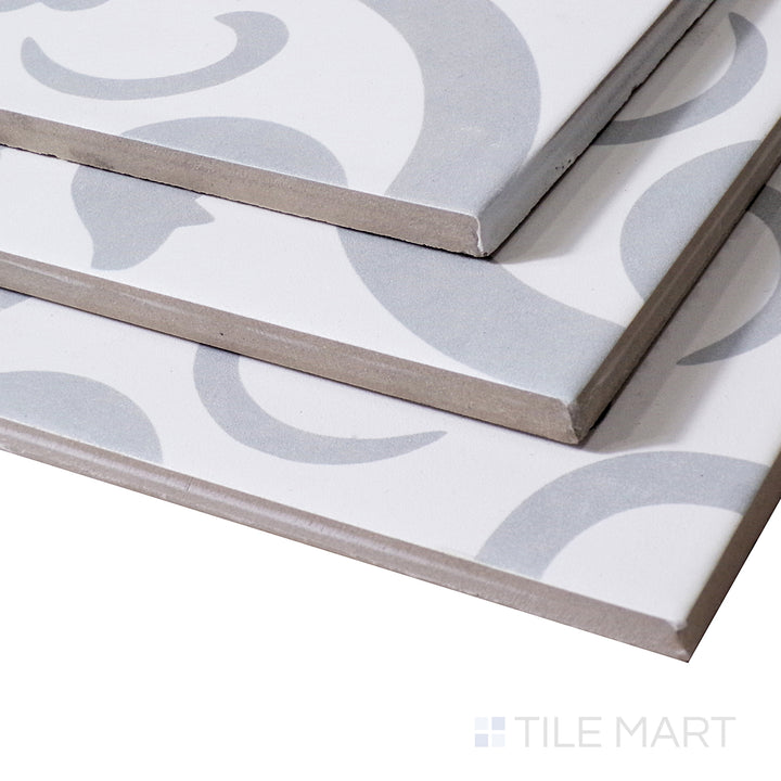 Soft light reflects off the delicate pattern of Perla Chic, highlighting its refined matte texture from an angled perspective.