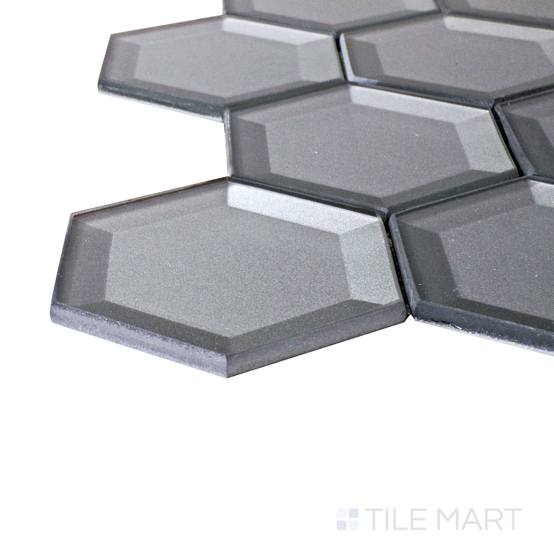 A corner perspective of the Bold Glass Dark Grey 3" hexagon glossy mosaic tile emphasizes its sleek dark gray tone and polished surface, perfect for sophisticated and industrial-inspired spaces.