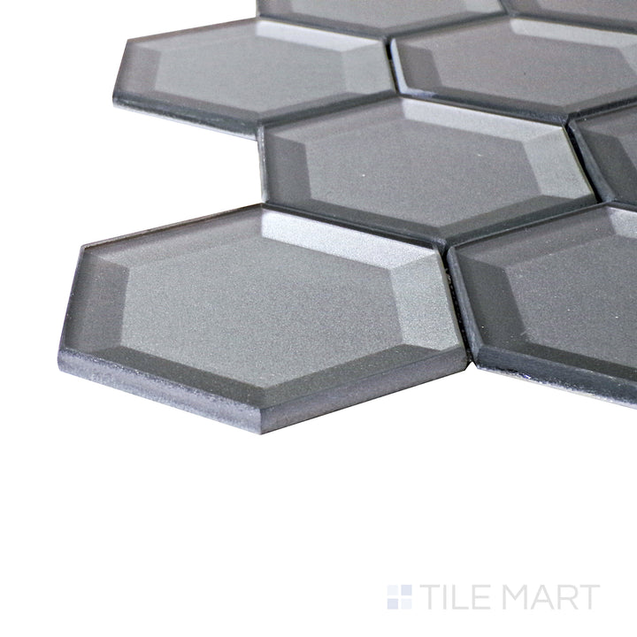 A corner perspective of the Bold Glass Dark Grey 3" hexagon glossy mosaic tile emphasizes its sleek dark gray tone and polished surface, perfect for sophisticated and industrial-inspired spaces.