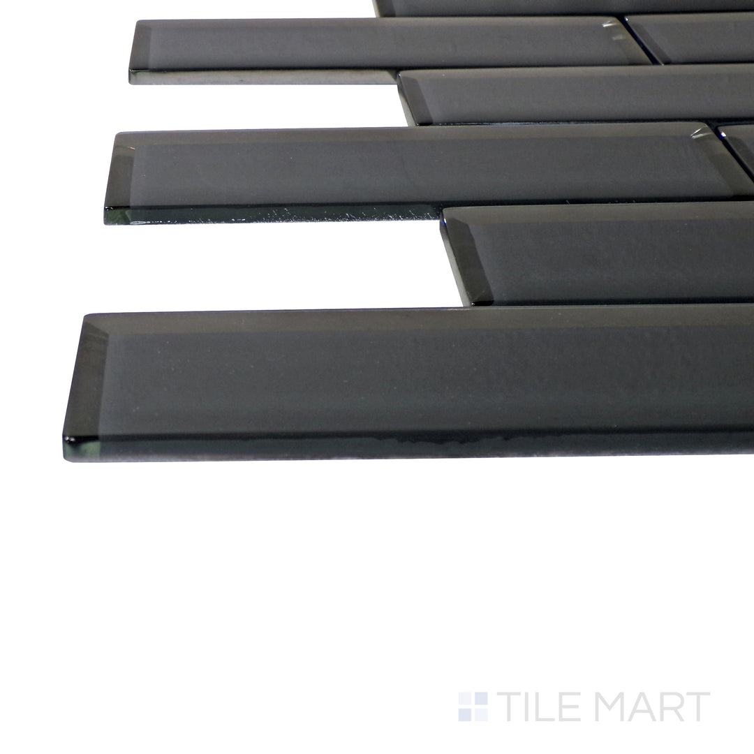 A corner perspective of the Modern Glass Dark Grey Brick glossy mosaic tile emphasizes its rich dark gray tones and reflective finish, creating a sophisticated and urban aesthetic.