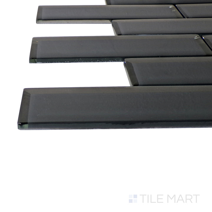 A corner perspective of the Modern Glass Dark Grey Brick glossy mosaic tile emphasizes its rich dark gray tones and reflective finish, creating a sophisticated and urban aesthetic.