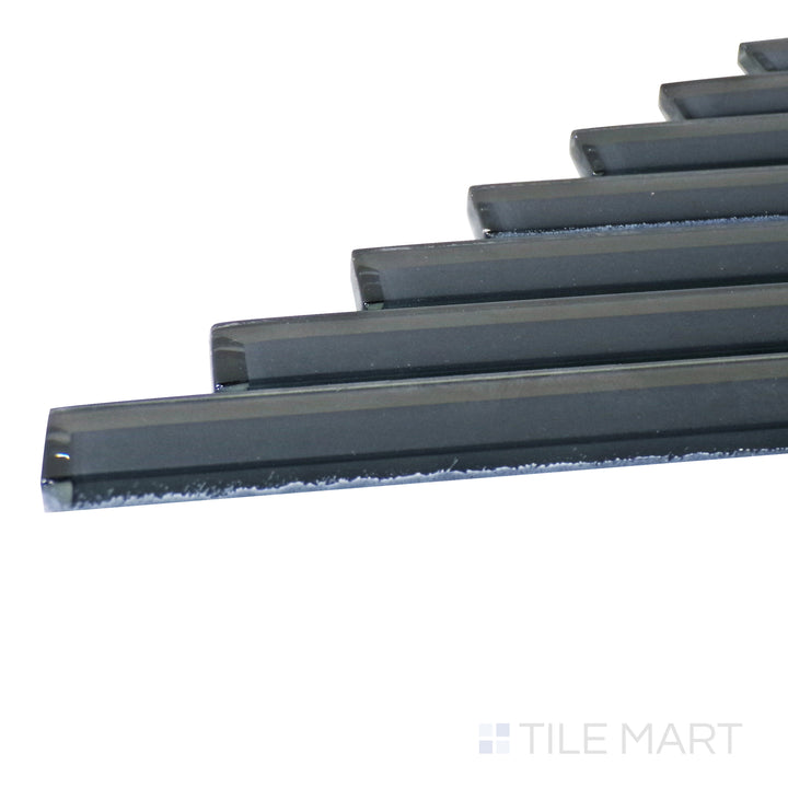 A corner perspective of the Modern Glass Dark Grey Herringbone glossy mosaic tile emphasizes its refined dark gray color and glossy texture, creating a dramatic and upscale look.