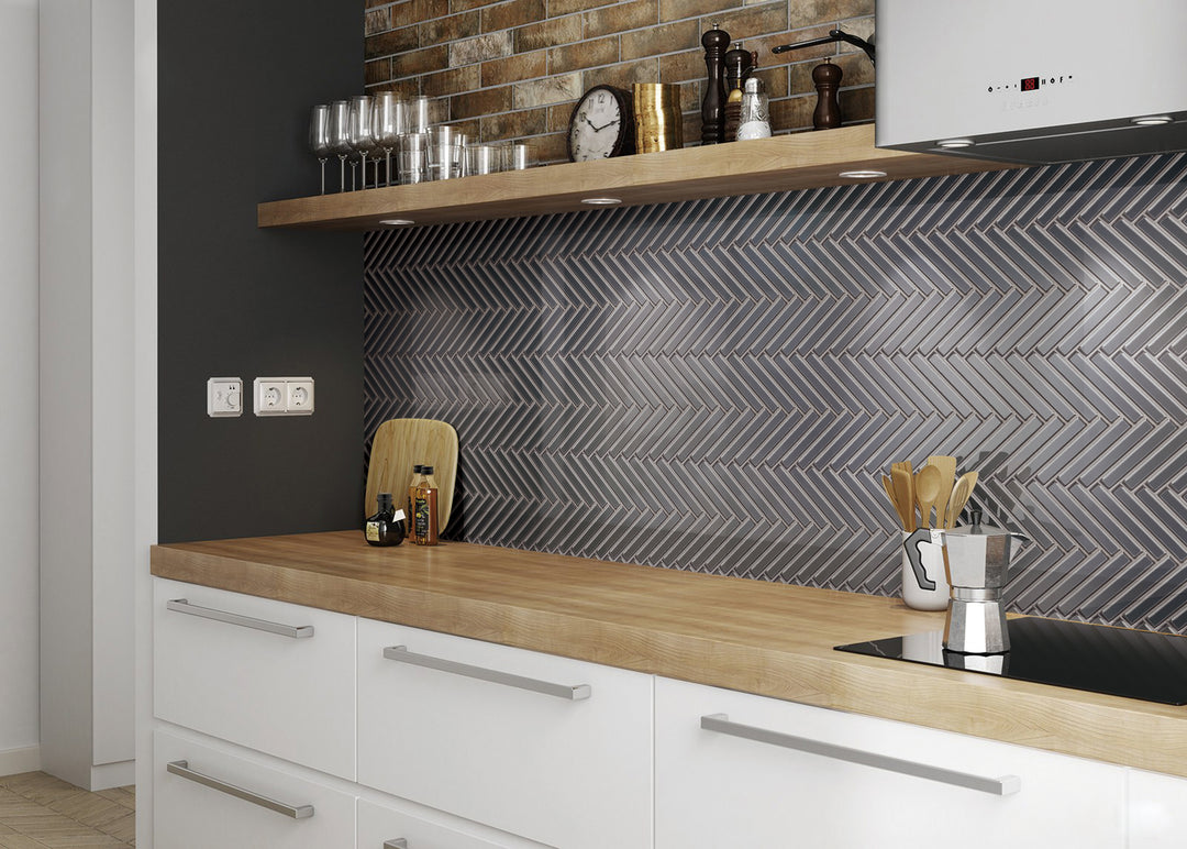 A bold, structured ambiance highlighted by Modern Glass Dark Grey Herringbone glossy mosaic, offering dynamic texture with a polished sheen.