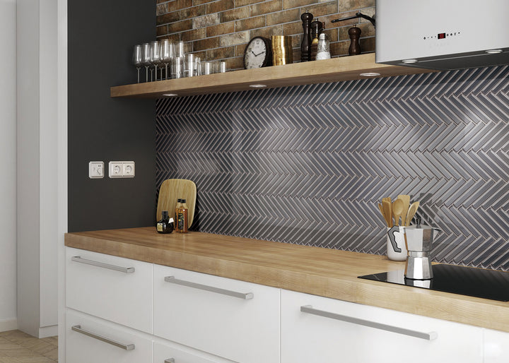 A bold, structured ambiance highlighted by Modern Glass Dark Grey Herringbone glossy mosaic, offering dynamic texture with a polished sheen.