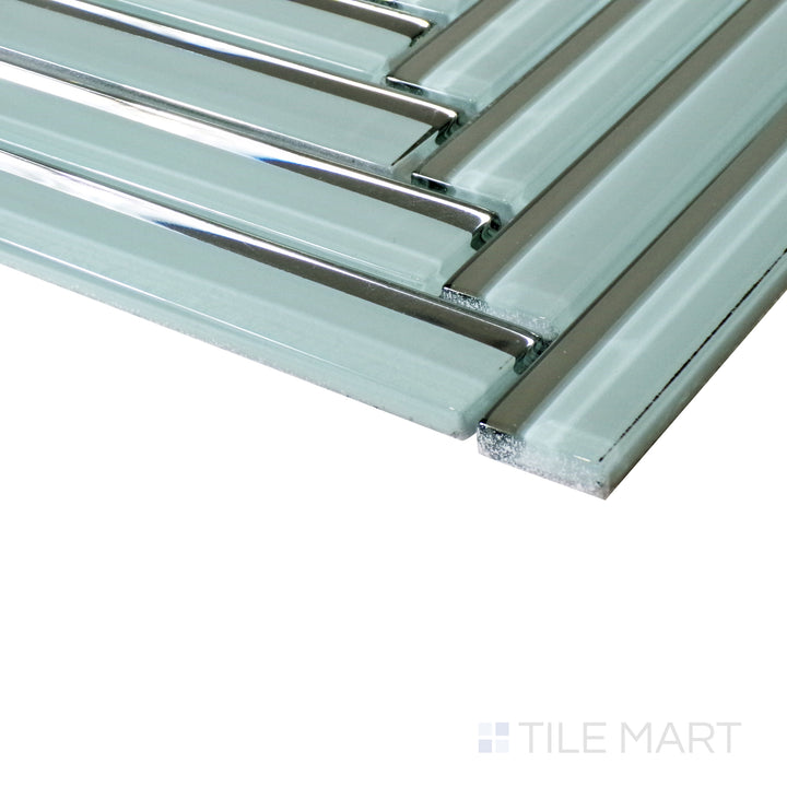 The dark grey herringbone layout appears dynamic from an angled perspective, capturing the interplay of light on its glossy finish.