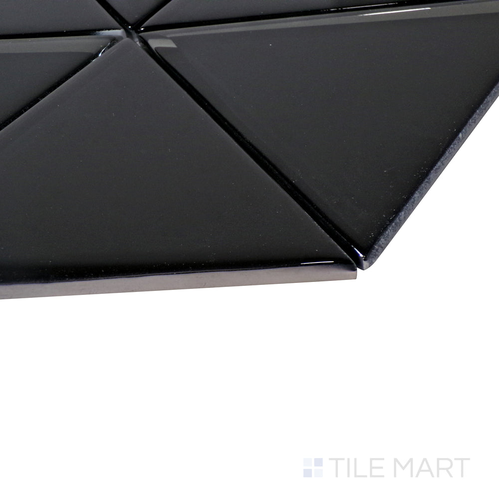 A fresh white herringbone mosaic shines under the light, with an angled perspective accentuating its elegant glass texture.