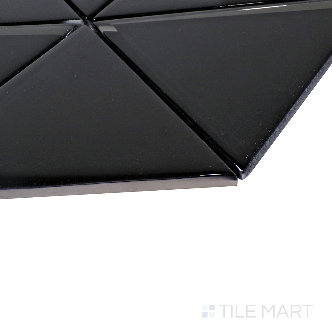 A fresh white herringbone mosaic shines under the light, with an angled perspective accentuating its elegant glass texture.