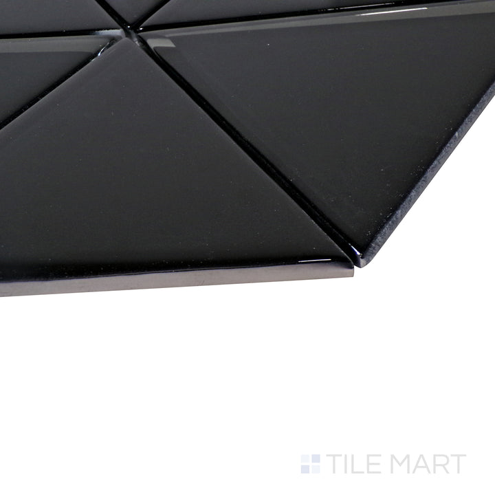 A fresh white herringbone mosaic shines under the light, with an angled perspective accentuating its elegant glass texture.